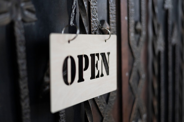 Photo open sign hanging on gate