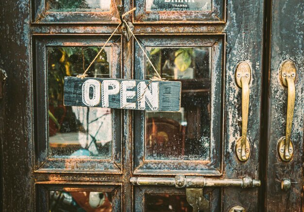 Photo open sign hanging on vintage door