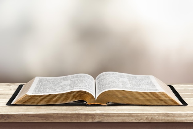 Open vintage christian bible on desk