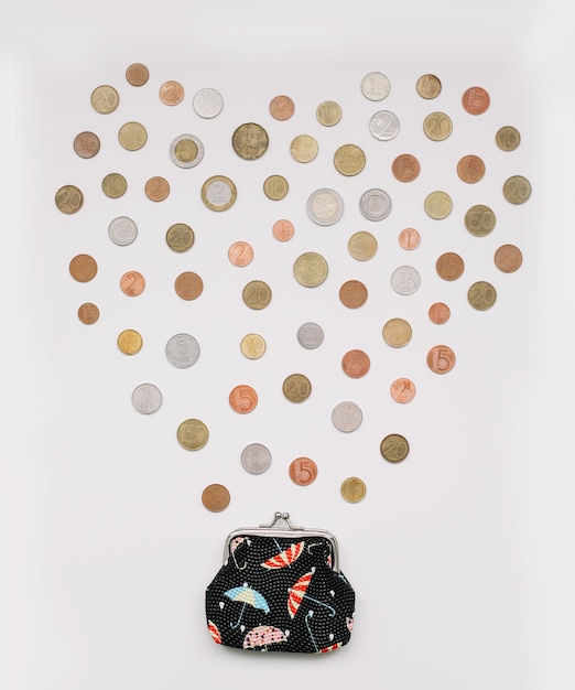 Open wallet with different coins isolated on white background top view Financial crisis poverty lack of money concept