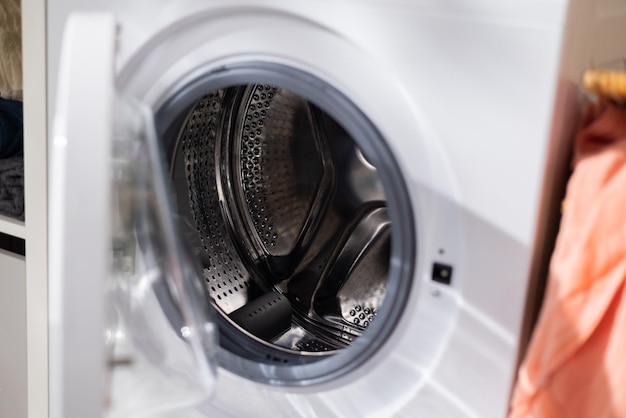 Open washing machine door empty drum clean interior laundry\
room