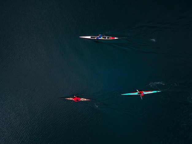 Open water group of sport kayaks and canoes aerial view