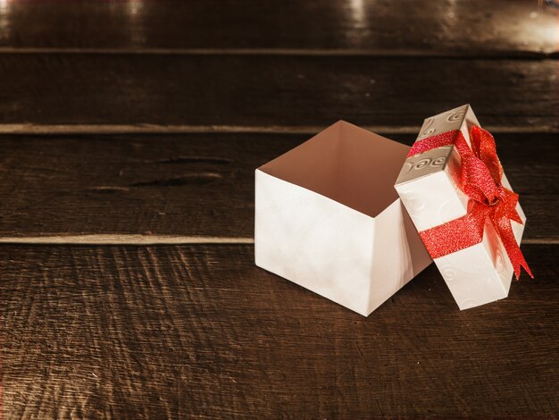 Open white gift box on wood desk