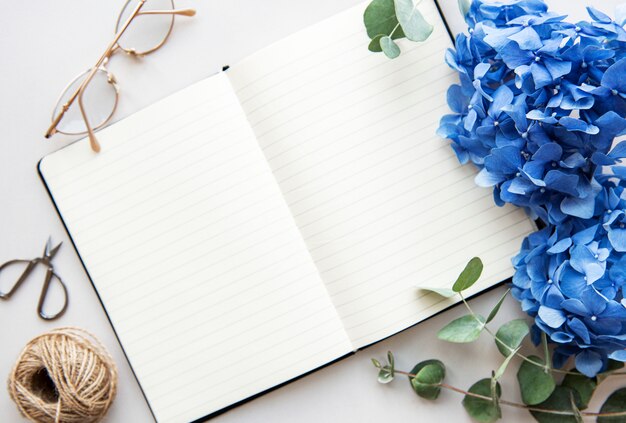 Open white notebook with blue flowers