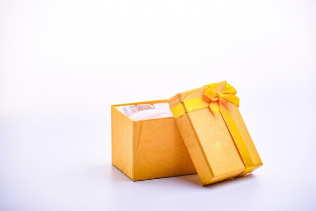 A open yellow gift box with ribbon