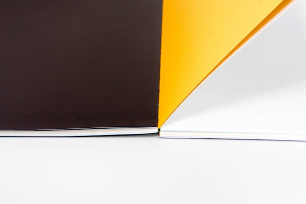 Opened blank book at white black yellow design paper background.