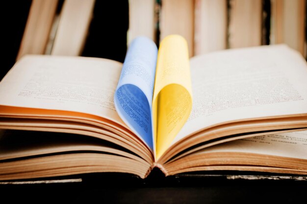 Opened book with heart shaped page Heart from book page valentine's day