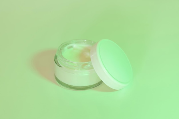 Opened Cosmetic jar with a lid close up mockup Green light Everyday skincare routine