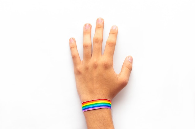 Opened hand with LGBT bracelet isolated on white background