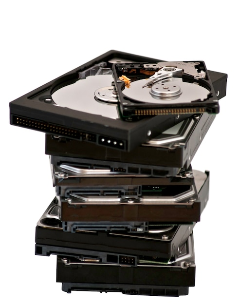 Opened hard disk drive liying on other hard drive