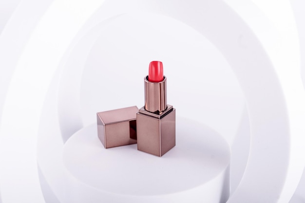 Opened lipstick on props on white background