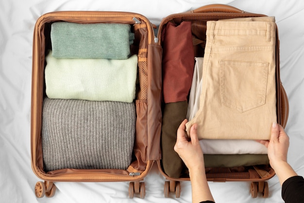 Photo opened luggage with folded clothes