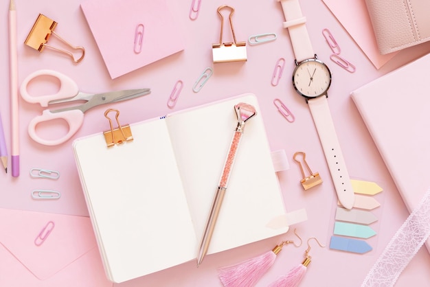Opened notebook and Pink school girly accessories on pastel pink Top view mockup