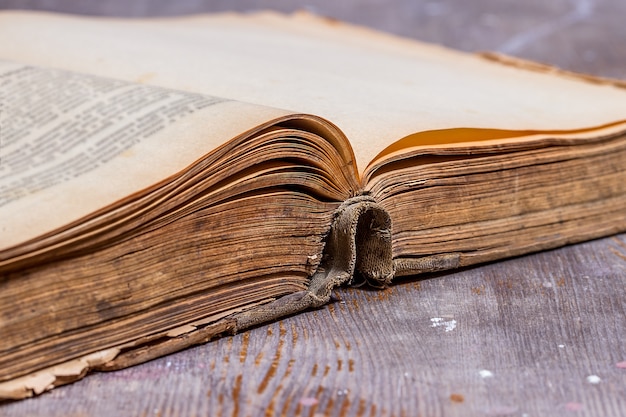 Opened old book on rustic table