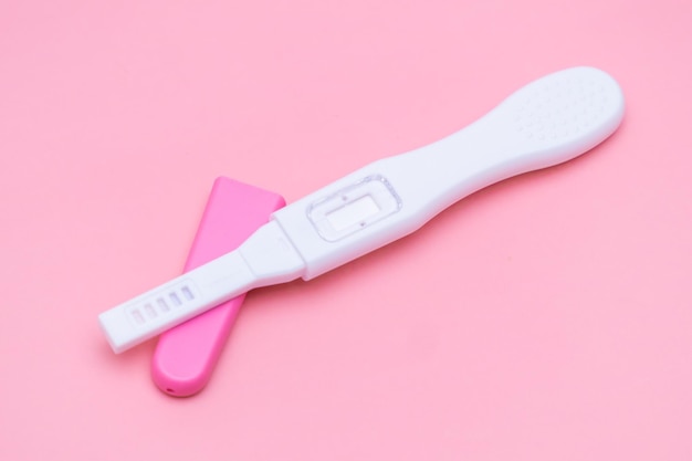 Opened pregnancy test isolated on the pink background