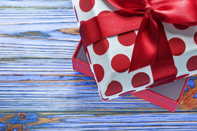 Opened present box with ribbon on vintage wooden board