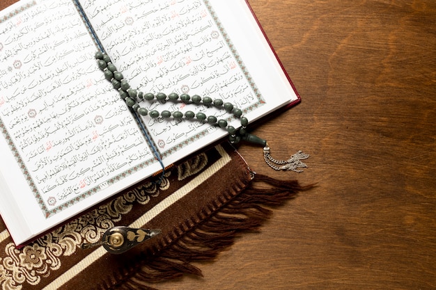 Opened quran on wooden background