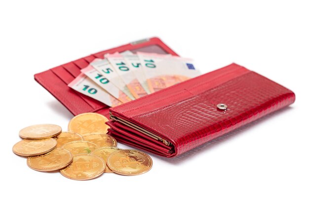 Opened red women purse with euro banknotes inside and bitcoin coins isolated on white