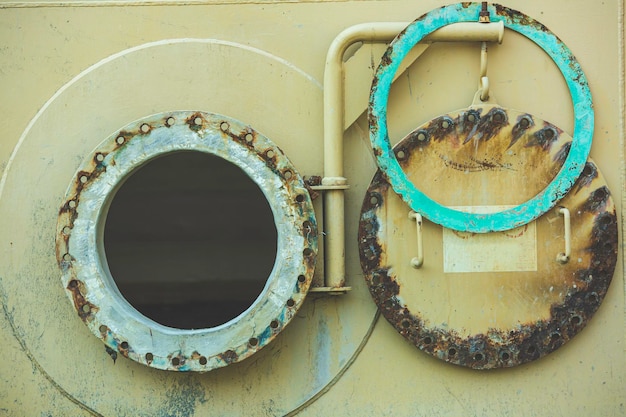 Opened rusty manhole on the fuel tank shell storage tank confined space