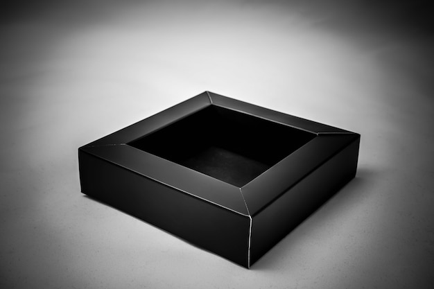 Opened small black box Empty inside and made from cardboard mockup on a gray background