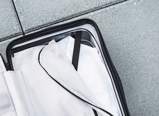 Photo opened suitcase with white shirt