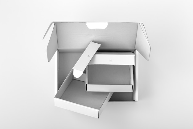 Opened white boxes on white background, top view