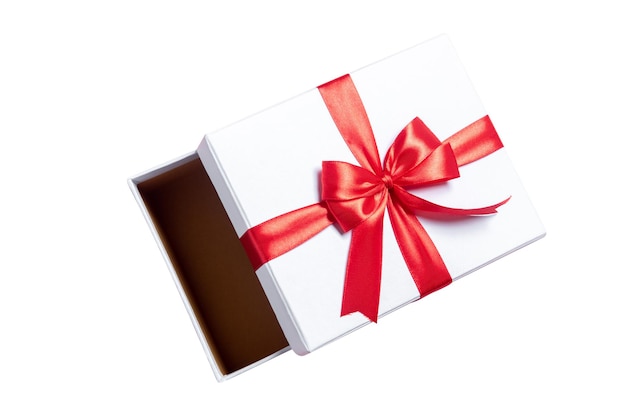 Opened white gift box with red ribbon isolated over white background