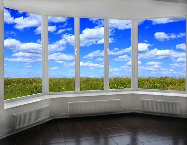 opened window to the summer field with flowers