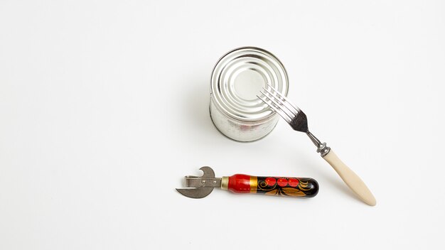 Opener with wooden fork and shiny metal tin