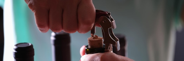 Opening bottle of wine on dark background quality wine selection and tasting