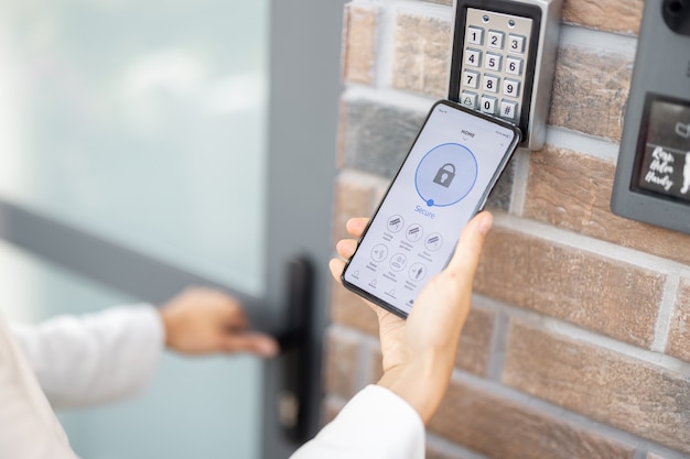 Photo opening door with a smart phone and keyboard on the wall