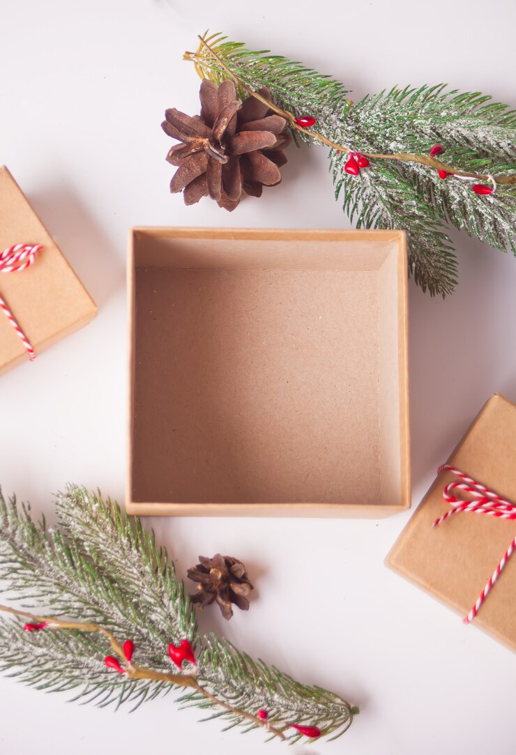 Photo opening and empty christmas gift box with pine branch and christmas decoration