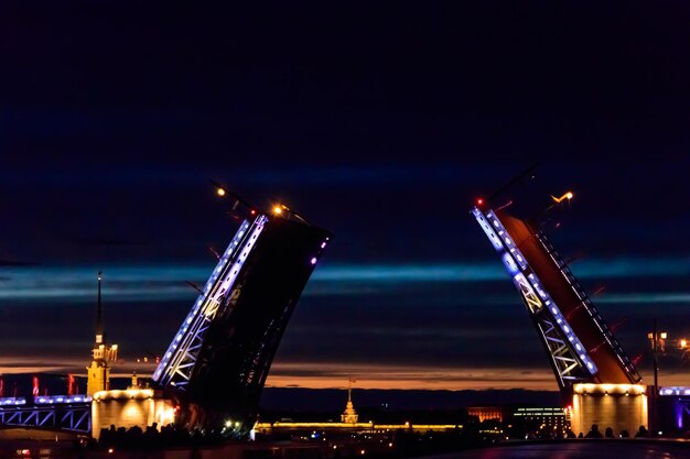 Opening of Palace drawbridge Night view of Palace bridge from the Neva river in Saint Petersburg Russia