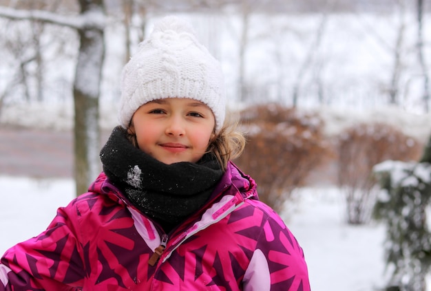 Openluchtportret van leuk glimlachend meisje in de winter