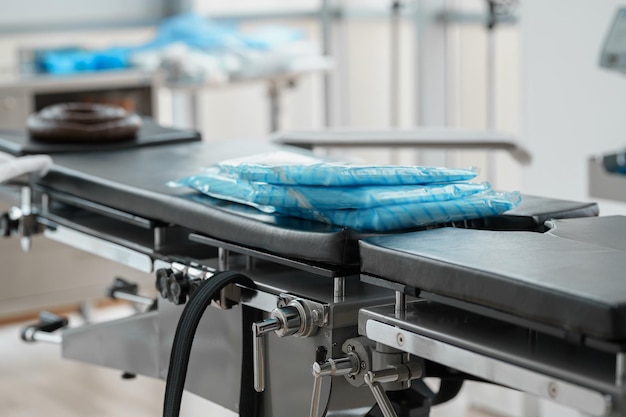 Operating table with medical capes ready for surgery in hospital