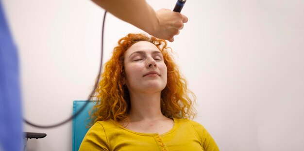 An ophthalmologist checking the eye pressure of her long term patient