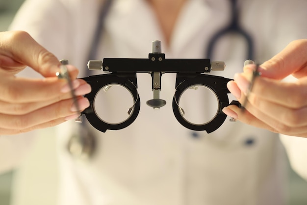 Ophthalmologist holds special ophthalmic glasses for checking vision closeup concept of