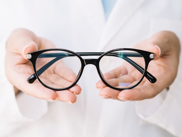 ophthalmologist showing pair of eyeglasses