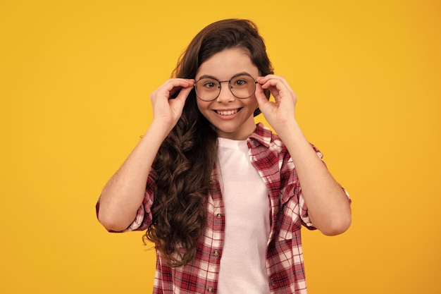 Ophthalmologist tries on eyeglasses of teenager little girl closeup Treatment of childrens vision with glasses Happy teenager positive and smiling emotions of teen girl
