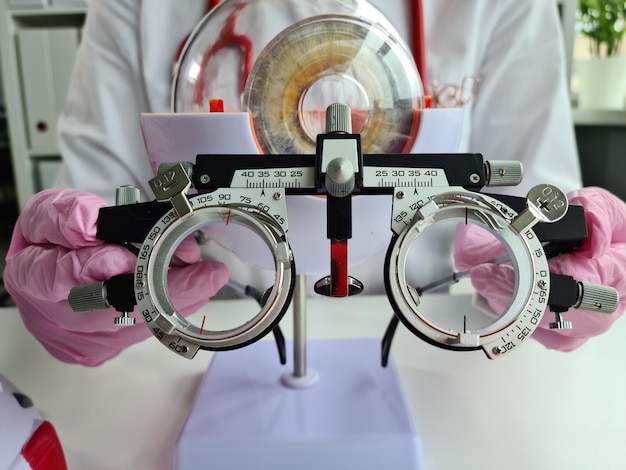 Ophthalmologist with trial frame for selection of complex glasses