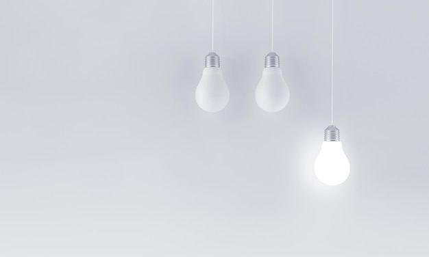 Opknoping verlichte gloeilamp op minimalistische witte achtergrond innovatieconcept