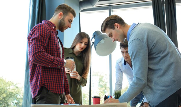 Opstarten business team op bijeenkomst in moderne, lichte kantoorinterieur brainstormen werken op laptop en tabletcomputer