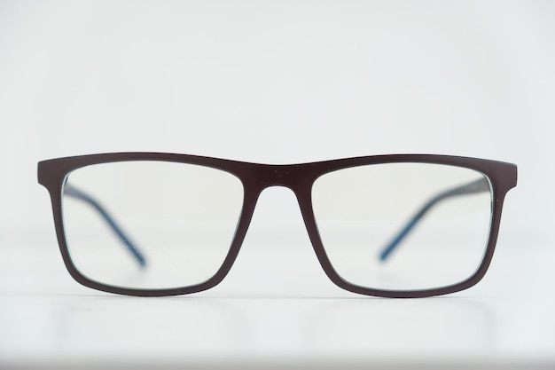 Optical glasses in a dark frame on a white background. Copy, empty space for text