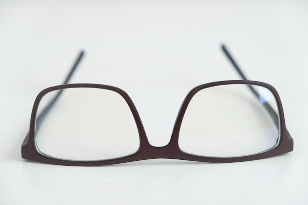 Optical glasses in a dark frame on a white background. Copy, empty space for text