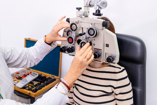 Optician and optometrist Eye doctor using phoropter
