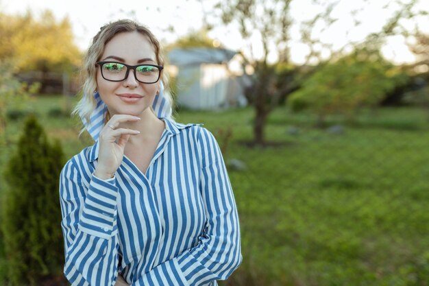 Optics for vision and fashion A sexy girl looks at the camera on her glasses Beautiful look through the frames closeup