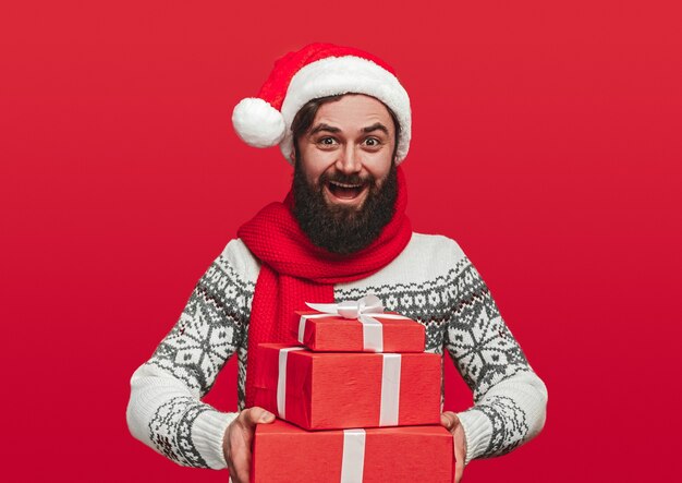 Optimistic bearded male in Santa hat