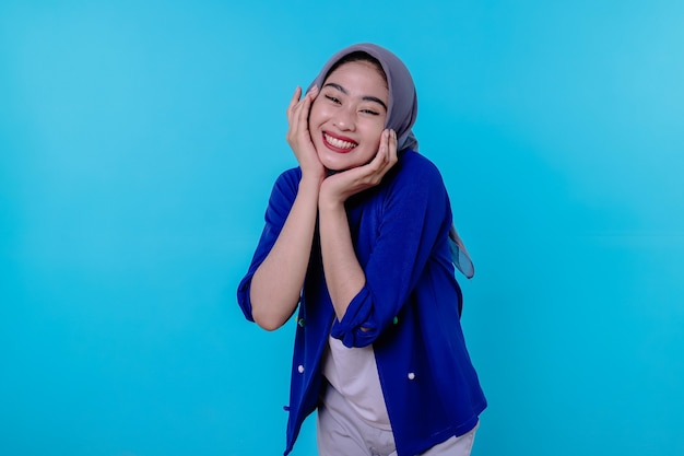 Optimistic charming attractive young woman with cute smiling joyfully with nice white smile on light blue background