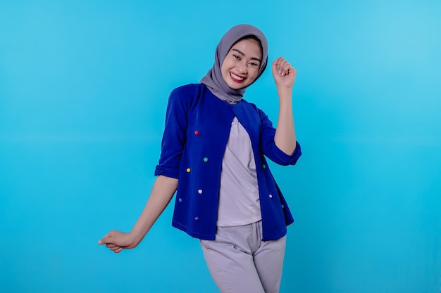 Optimistic charming attractive young woman with cute smiling joyfully with nice white smile on light blue background