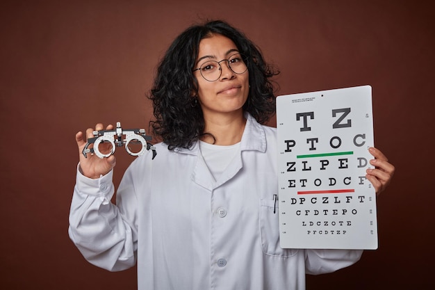 Optometrist checking a patient's vision with glasses and a test